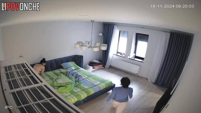 Lonely lady making her bed after sleep, hidden camera