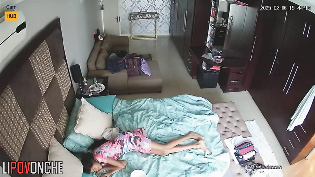 Sisters chilling now - one is lying on the bed and the other is getting dressed