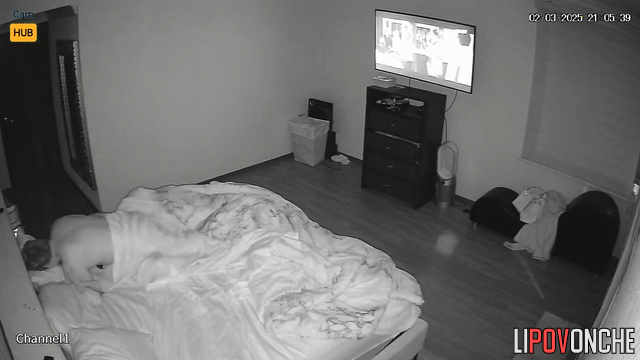 The husband relaxes while watching TV while his wife gives him a blowjob