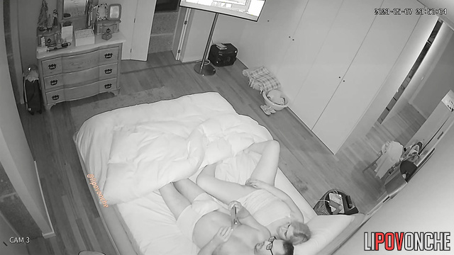 She satisfies herself while lying next to her husband on the bed