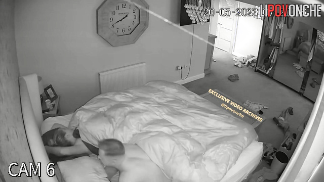 A waking husband reaches for his wife's seductive naked breast