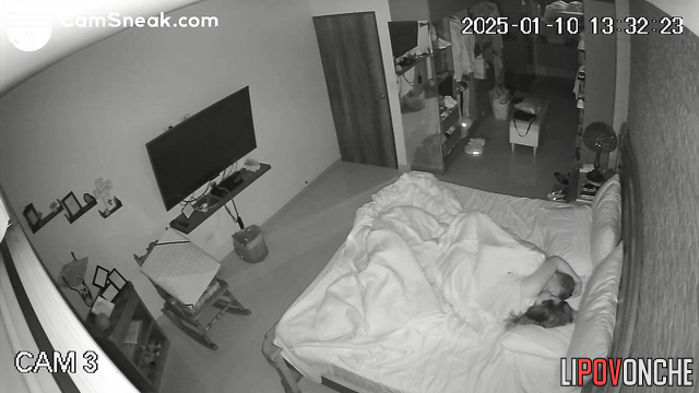 Spouses teasing each other in warm bed, hidden tape