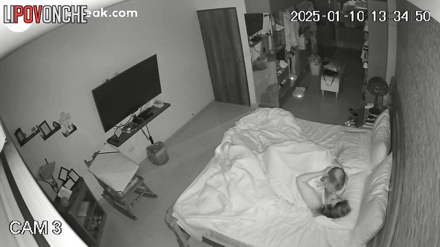 Spouses teasing each other in warm bed, hidden tape