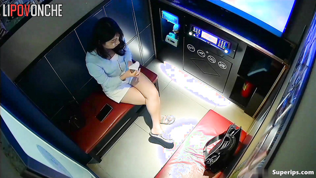 Asian couple singing their favorite songs at karaoke club