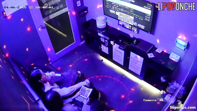 Asian best friends singing in a cool karaoke club, hidden video