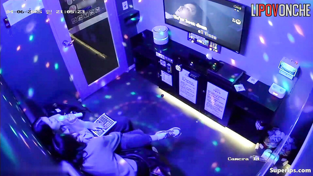 Asian best friends singing in a cool karaoke club, hidden video