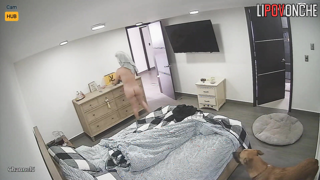 She is alone in the room and does not suspect that she is being watched