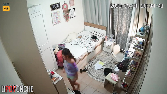 Petite brunette singing and looking at herself in the mirror