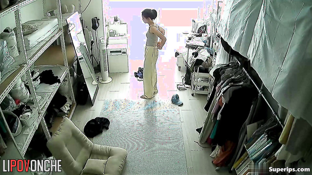 Asian woman looking thoughtfully at herself in the mirror