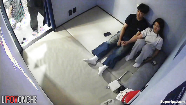 A Korean couple passionately caresses each other while watching a movie