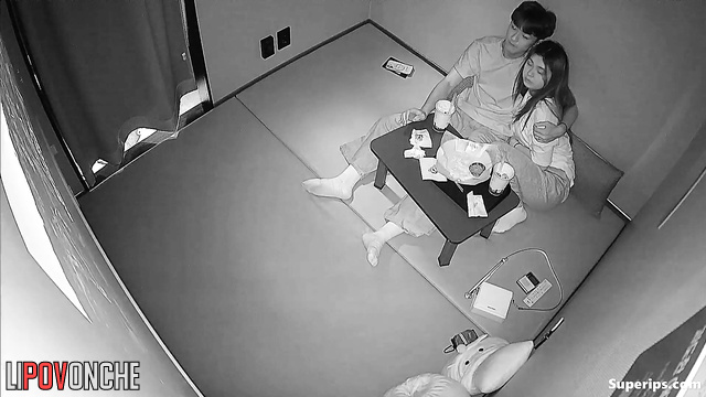A Korean couple passionately caresses each other while watching a movie
