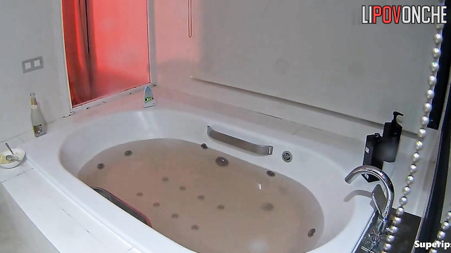Girls teasing each other in the bathroom after champagne
