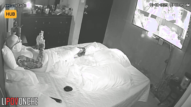 Tattooed guy in glasses watching boring v before sleep