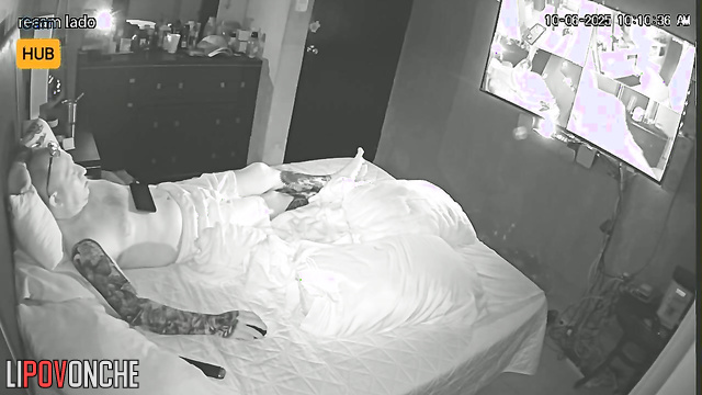 Tattooed guy in glasses watching boring v before sleep