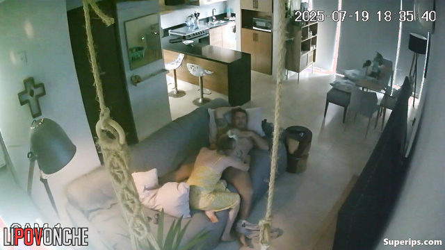 A sly blonde plays with her boyfriend's penis under his shorts