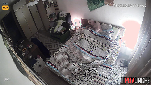 Old spouses relaxing in bed, unaware each move is captured on camera