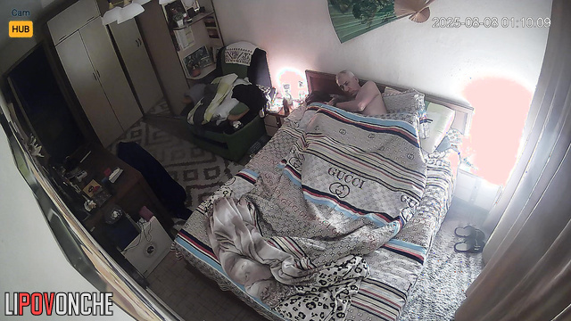 Old spouses relaxing in bed, unaware each move is captured on camera