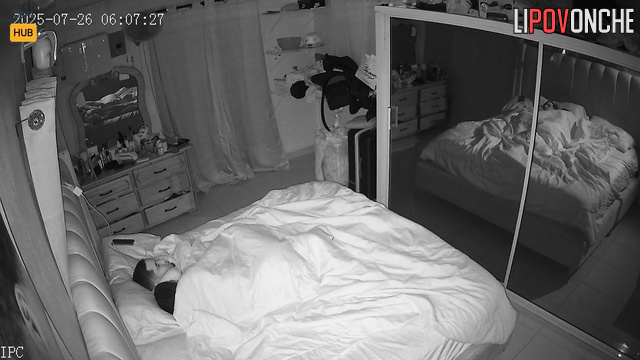 Lovers relax in bed, unaware each move is captured on tape