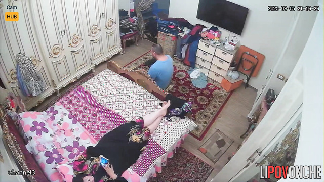Chubby couple lying on bed, unaware a hidden lens records them