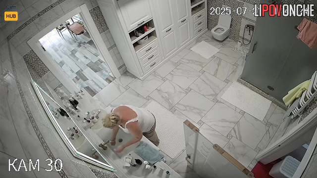 Blonde peeing, not knowing each move is captured, look