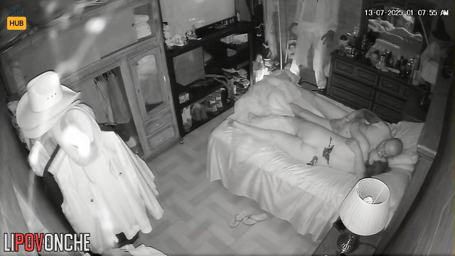 Spouses resting together, blind to the secret surveillance
