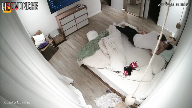 Lovers rest together, blind to the secret surveillance
