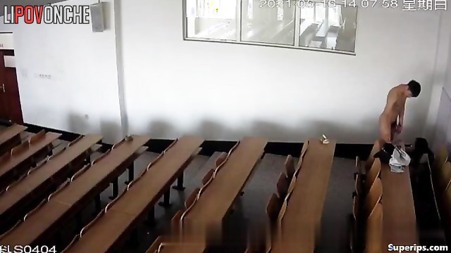 Young students actively engage in sexual activity in a large lecture hall