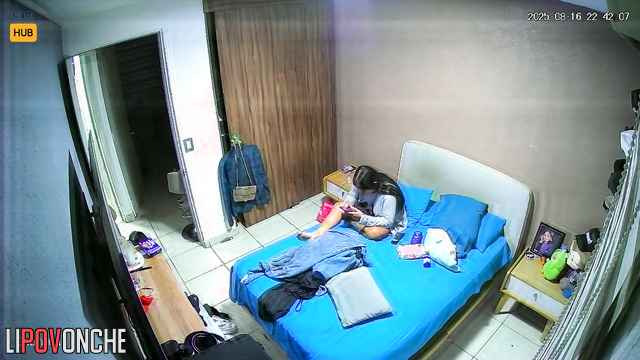 Couple gets dressed and unaware there is a tiny cam installed above the door