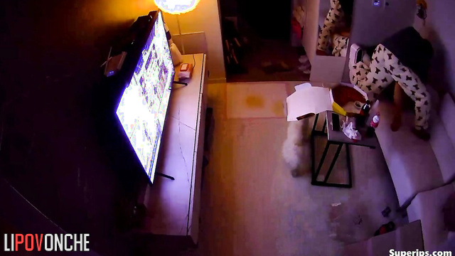 Asian couple having sex in cowgirl position and watching tv