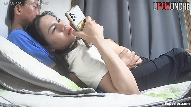 Young vietnamese couple hugging in the warm bed, look