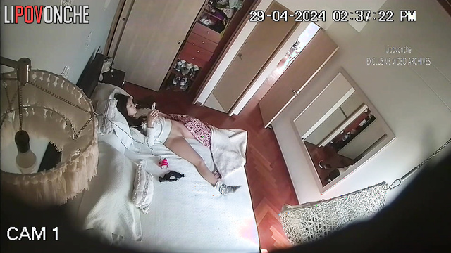 Skinny brunette masturbates with a vibrator on the bed