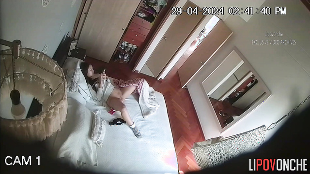 Skinny brunette masturbates with a vibrator on the bed
