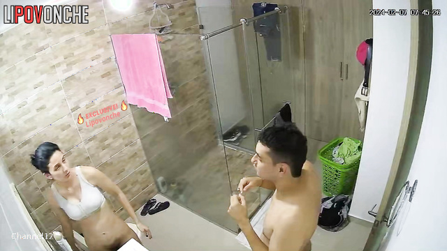 Guy carefully wipes his girlfriend with a towel after a shower