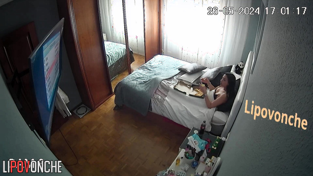 The brunette changed her clothes and began to relax in front of the TV