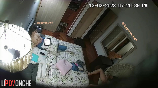 Topless brunette enjoys playing games on a tablet