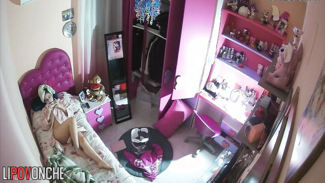 Girl teenager plays in her phone laying in bathrobe and having no lingerie on