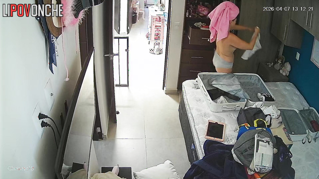 A completely naked beauty with a hairy pussy is packing for her vacation