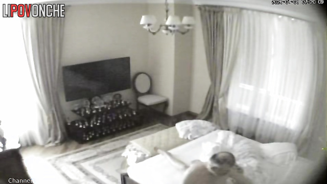 A bald older man gives his naked blonde wife a light massage