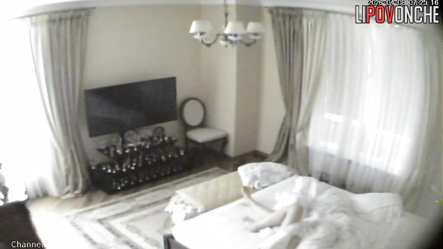 A bald older man gives his naked blonde wife a light massage