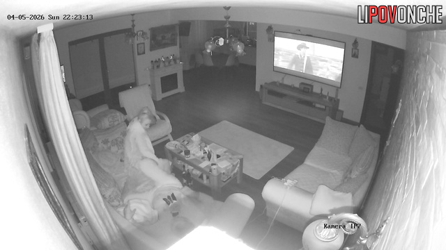 The horny milf impatiently pulls down her husband's underwear while he watches TV