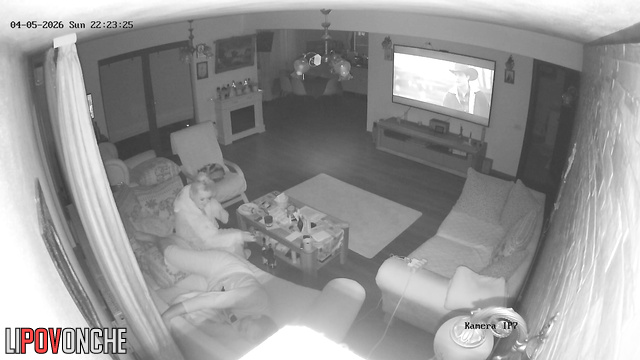 The horny milf impatiently pulls down her husband's underwear while he watches TV