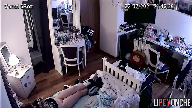 A bored redheaded girl caresses her hot pussy with her legs spread wide