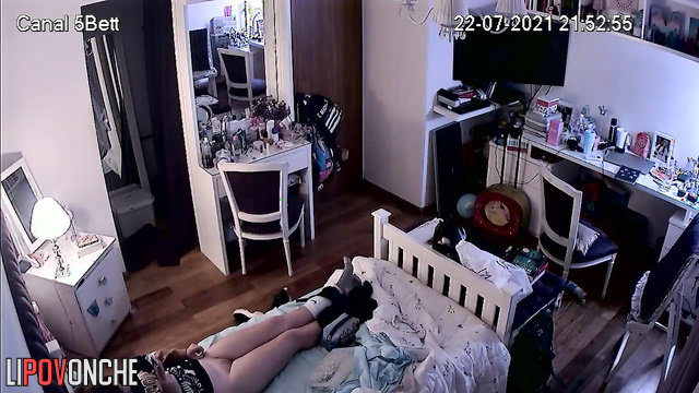 A bored redheaded girl caresses her hot pussy with her legs spread wide