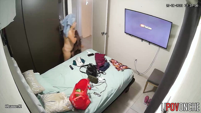 A naked woman with a sexy body puts a panty liner in her underwear