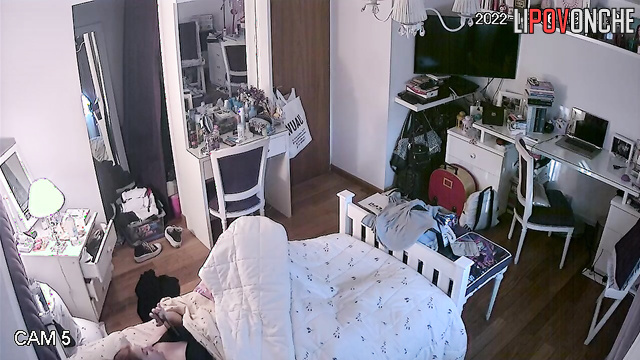 A young girl secretly strokes her tender, wet pussy under the covers