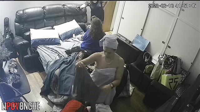 A naked mom gets dressed, ignoring her friends chatting in her bedroom