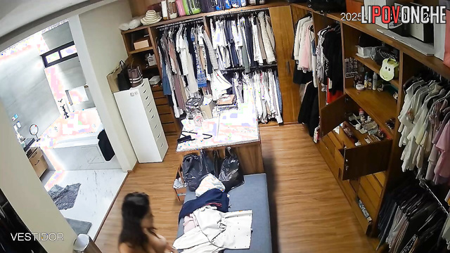 A completely naked brunette is choosing which panties she wants to wear today