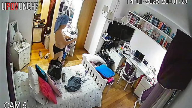 A red-haired student enters her bedroom completely naked after taking a shower