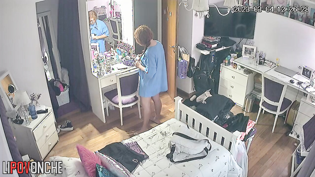 A stunning college girl pulls off her T-shirt, leaving herself in just her panties