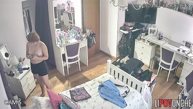 A stunning college girl pulls off her T-shirt, leaving herself in just her panties
